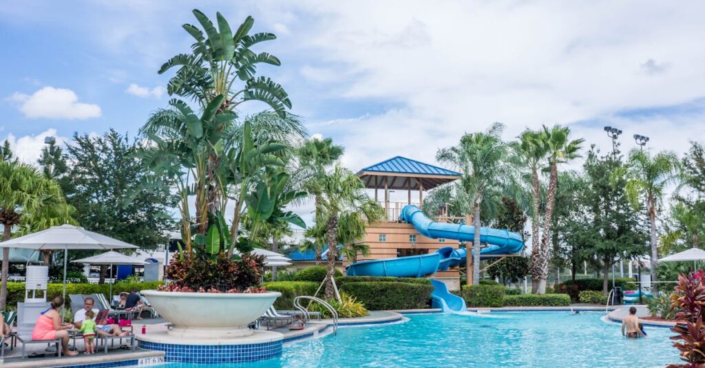 Vibrant tropical resort scene featuring a pool, waterslide, and lush palm trees, ideal for summer vacations.